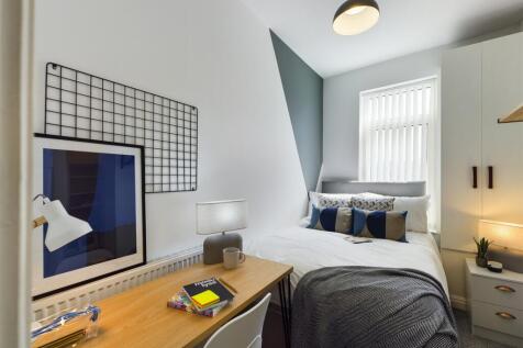 A stylish and well-lit double bedroom featuring...