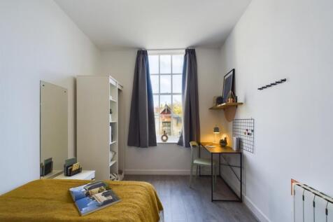 A bright and inviting double bedroom with ample...