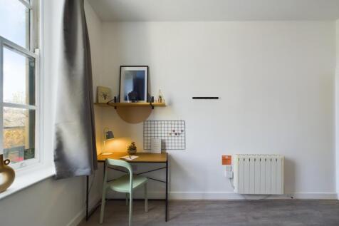 A bright and tidy double bedroom with a study a...