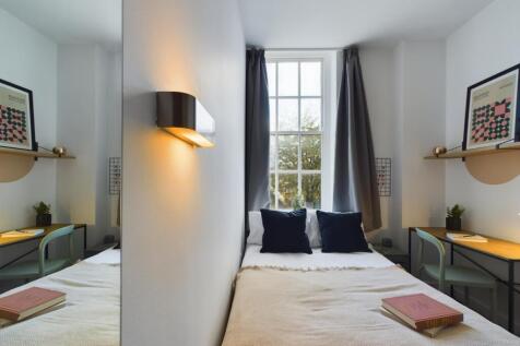 A bright and inviting double bedroom featuring ...