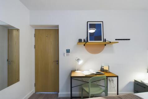 A bright and tidy double bedroom featuring a st...