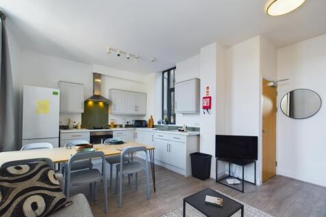 A modern and spacious kitchenette with ample na...