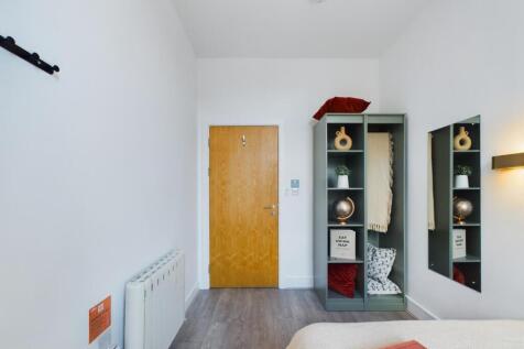 A bright and tidy double bedroom featuring styl...