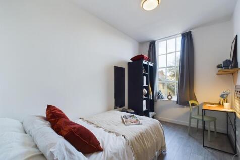 A bright and inviting double bedroom with a coz...