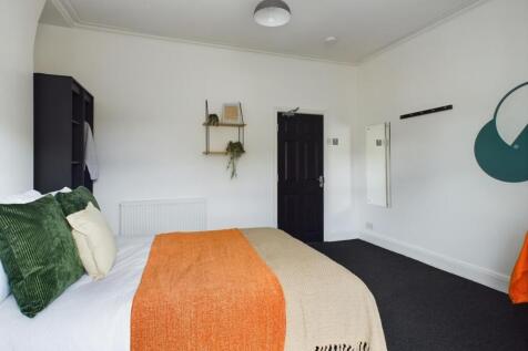 A spacious and inviting double bedroom with mod...