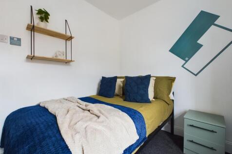 A stylish and inviting double bedroom with mode...