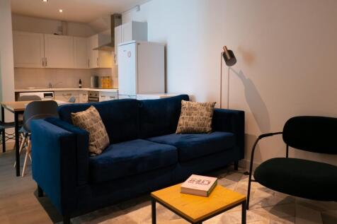 A stylish and spacious modern living room featu...