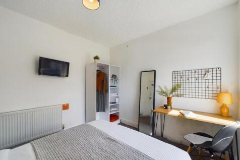 Bright and spacious master bedroom featuring a ...