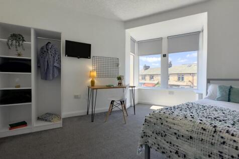 Bright and airy bedroom featuring a spacious be...