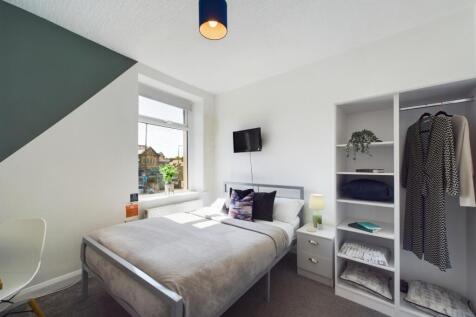A bright and modern bedroom featuring a double ...