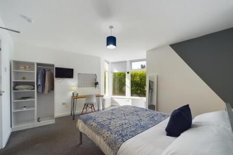 A bright, well-maintained bedroom featuring a c...