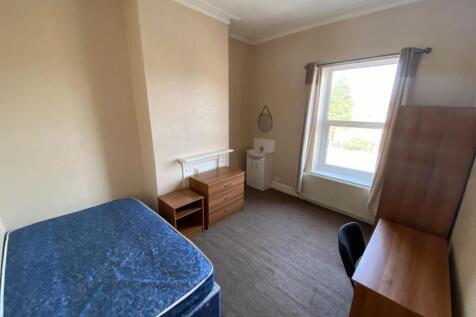 A spacious and well-lit double bedroom perfect ...