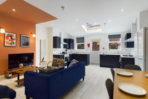 A spacious and modern kitchen area with ample n...