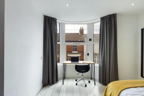 A bright and spacious double bedroom featuring ...