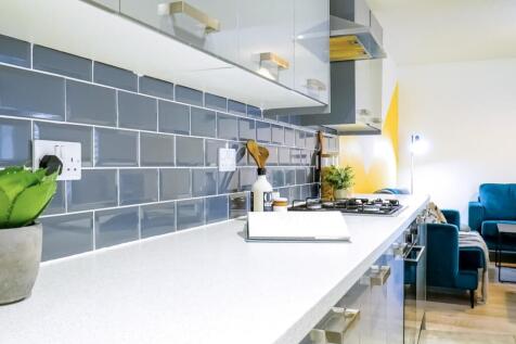 A modern kitchenette with sleek cabinetry and a...