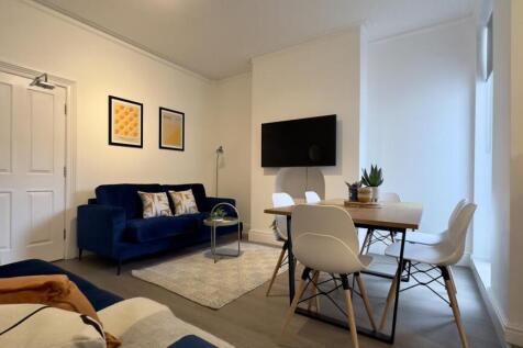 A spacious and inviting modern living room perf...