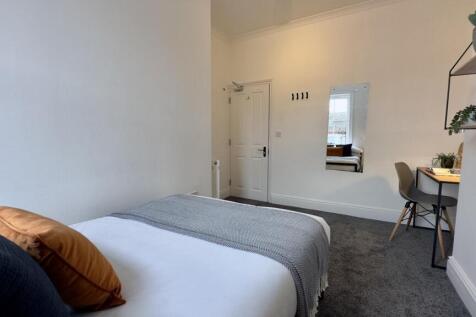 A spacious and inviting double bedroom with mod...