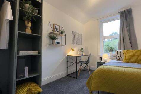 A bright and inviting double bedroom featuring ...