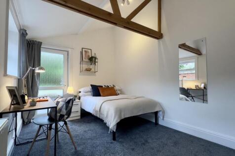 A spacious and bright double bedroom with moder...