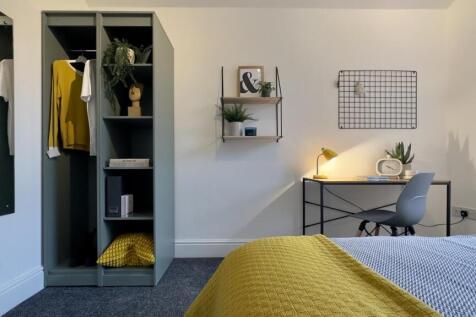 A bright and stylish double bedroom featuring m...