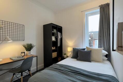 A bright and inviting double bedroom featuring ...