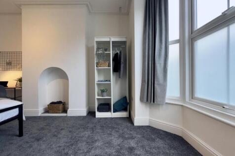 A spacious and bright double bedroom featuring ...