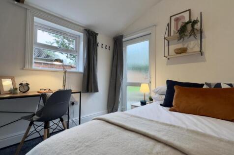 A bright and inviting double bedroom featuring ...