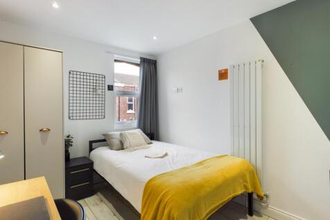 A bright and inviting double bedroom featuring ...