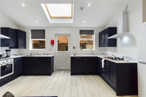 A modern and spacious kitchen with ample natura...