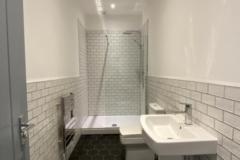 A modern and stylish bathroom featuring a spaci...