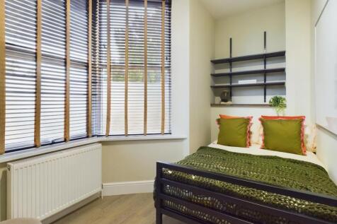 A bright and inviting double bedroom featuring ...