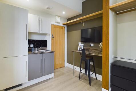 A modern kitchenette with a sleek design and am...