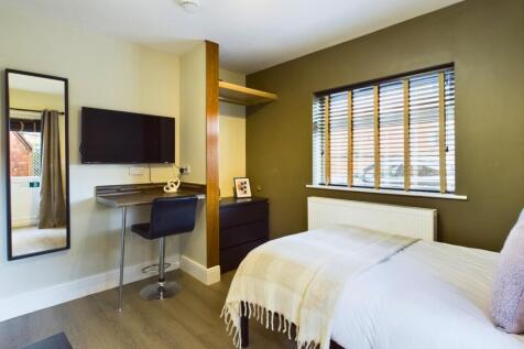 A stylish and well-lit double bedroom featuring...