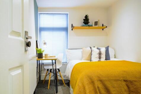 A bright and inviting double bedroom featuring ...