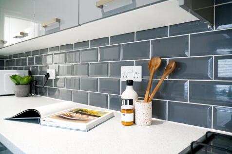 A modern and tidy kitchenette with stylish grey...