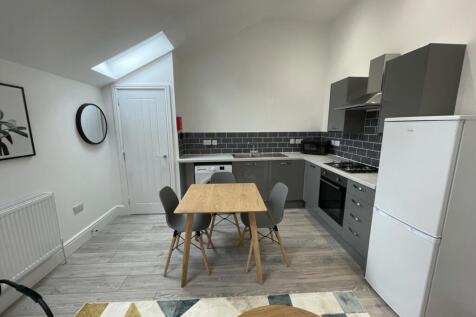 A bright and modern kitchenette with ample spac...