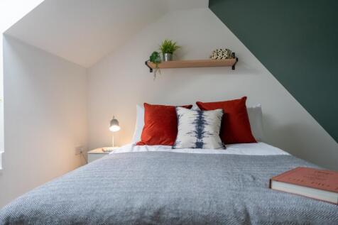A bright and inviting double bedroom featuring ...