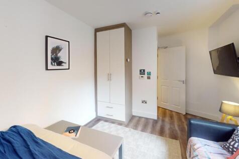 A bright and tidy double bedroom featuring mode...