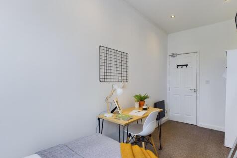 A bright and inviting double bedroom featuring ...