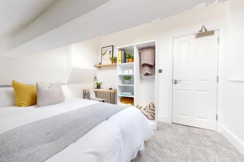 A bright and spacious double bedroom featuring ...