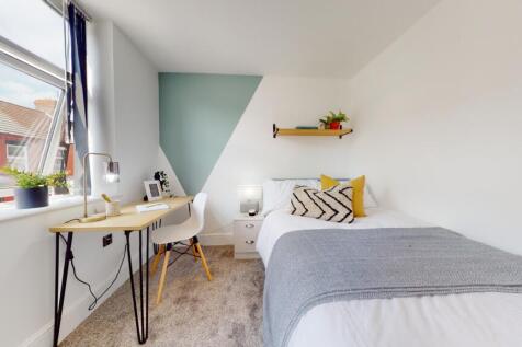 A bright and stylish double bedroom featuring a...