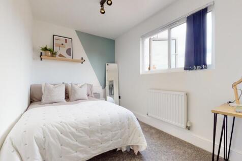 A bright and inviting double bedroom featuring ...