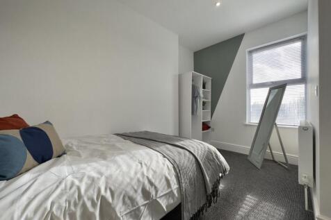 A spacious and bright double bedroom featuring ...