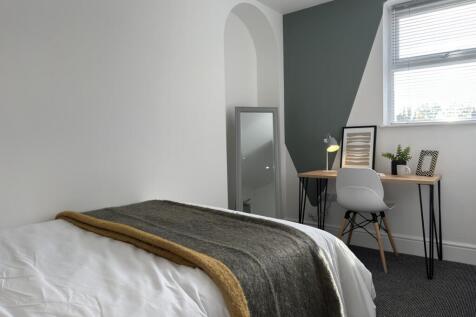 A bright and inviting double bedroom with moder...