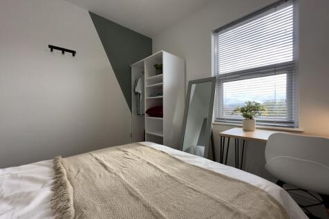 A bright and inviting double bedroom featuring ...