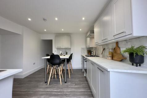 A modern and spacious kitchen with ample natura...