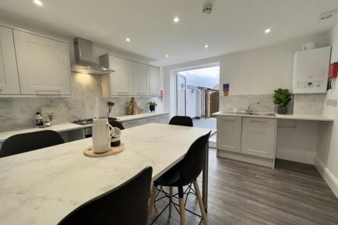 A modern and spacious kitchen with ample natura...