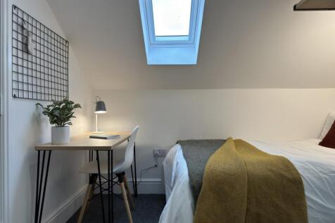 A bright and inviting double bedroom featuring ...