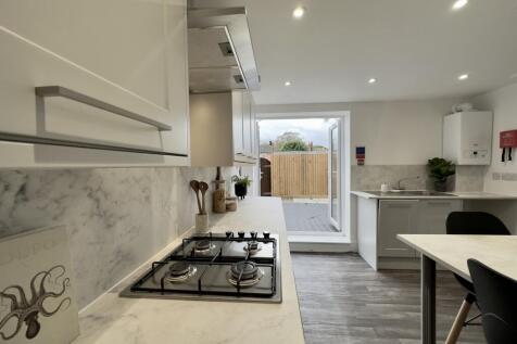 A bright and modern kitchen with a stylish desi...