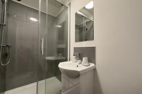 A modern and pristine bathroom featuring a spac...